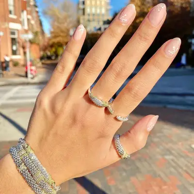 Peachy nude manicure with minimalist white snowflakes