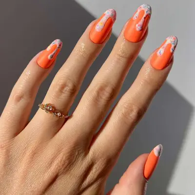 Matte orange ice cream nails with confetti drip 