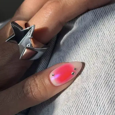 close up of blue ombre manicure with rhinestones