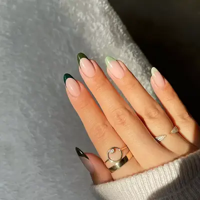 model with forrest green and light green French tip nails 