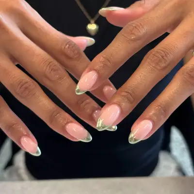 model with bare nails and chrome green French tips