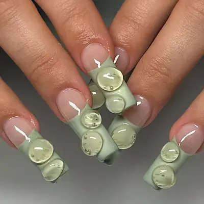 model with sage French tips with 3D bubbles