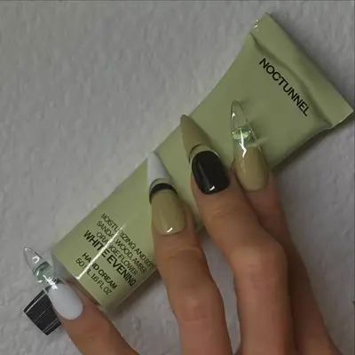 model with green, black, and white colorblocked nails
