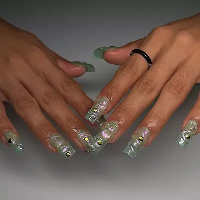 model with green iridescent nails with 3D swirl details and rhinestones
