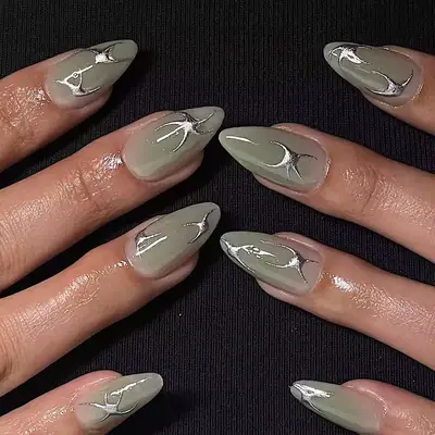 model with sage nails with silver abstract details