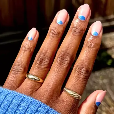 white french manicure with green swirl designs