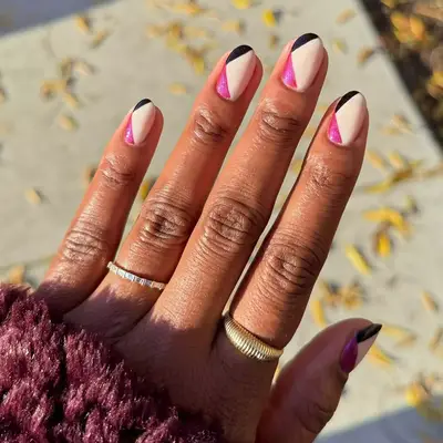 cream nails with black and hot pink angular design