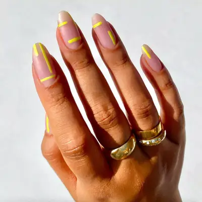 matte nude nails with yellow stripe designs 