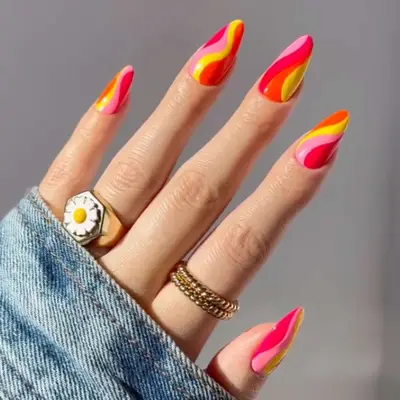 a swirl manicure in neon shades of yellow, orange, pink, and hot pink