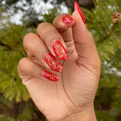 Red manicure with gold speckling