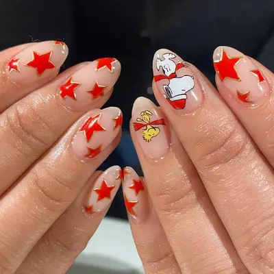 Red star manicure with gold border and Snoopy and Woodstock accent nails