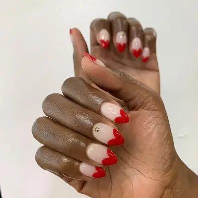 Heart-tipped manicure with gold stud accents