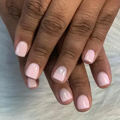 milky pink dip nails with sparkles 
