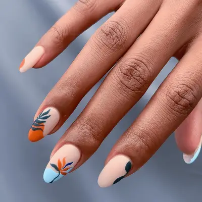 Matte nude manicure with colorful abstract botanical details