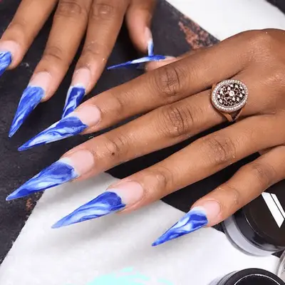 wavy blue stilletto nail manicure