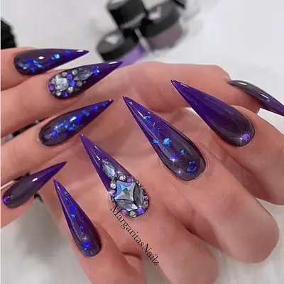 purple holograhic stilletto nails with crystals 