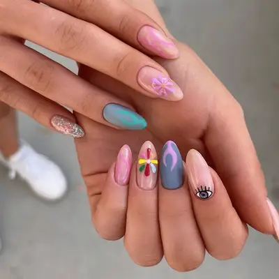 festival-themed stilletto nails featuring shades of purple blue and pink