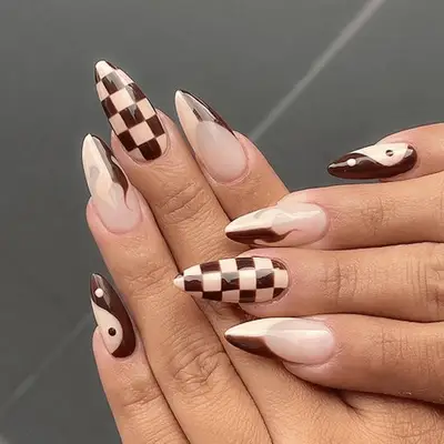 checkered milk and coffee stilletto nails with yin yang pinkie