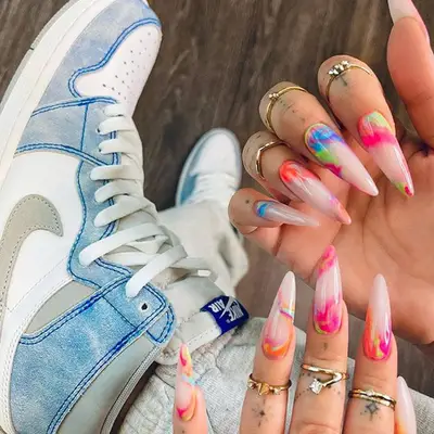 stilleto shaped nails with a tie dye design