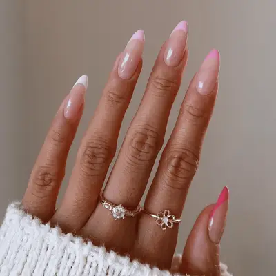 gradient pink tipped french manicure on stiletto shaped nails
