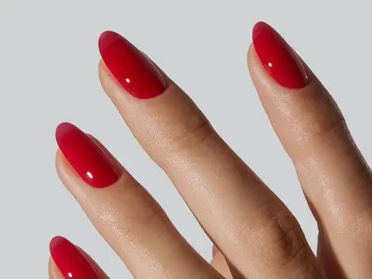 Close up of a short, oval red manicure