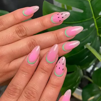 pink ombre reverse french manicure with green cuticles and seed designs