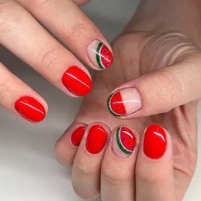 a bright red manicure with negative space watermelon designs