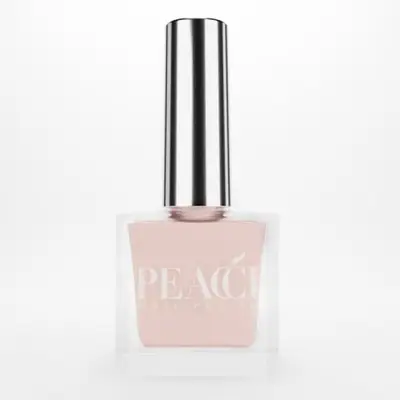 A bottle of Peacci nail polish with a metallic cap and pink polish