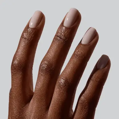 A hand with short, neatly manicured nails with a smooth finish