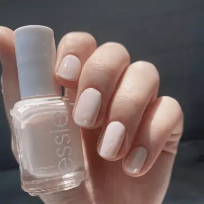 A round, smooth pink object placed in a square recess with shadows on a white background