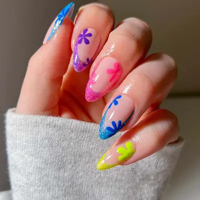 Asymmetric shimmer Skittle French tips with Spongebob-inspired flowers - MYM Beauty Summer French Manicures