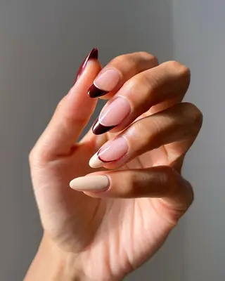 Dark cherry and cream-colored manicure and French tips 