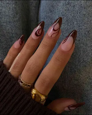Almond nails with chocolate brown French tips and swirl nail art