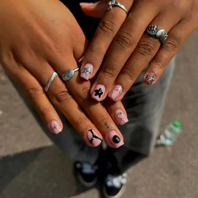 model with nails that have flower, star, and abstract designs