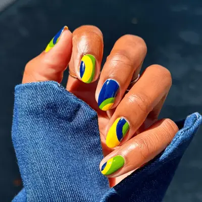Blue, green, and yellow swirl manicure