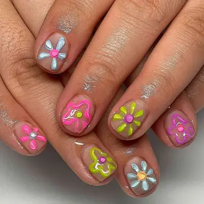nails with colorful 3d flowers in shades of pink, green, blue