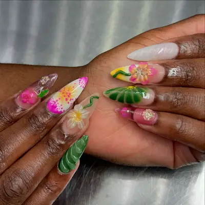 nails with pink and green and yellow 3d flowers