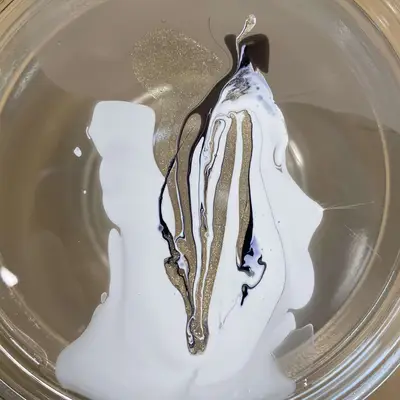 Swirled nail polish in a cup of water.