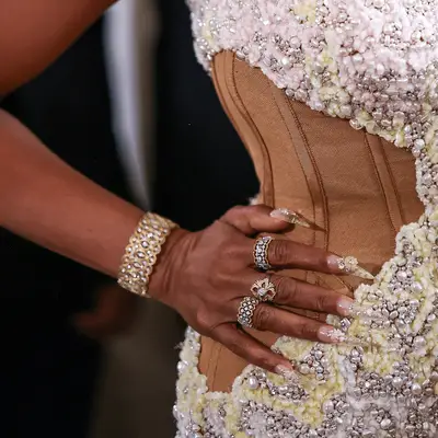 Taraji P. Henson at Met Gala wearing a strapless sweetheart neckline beaded corset dress with hand on hip showing off intricate bejeweled nails