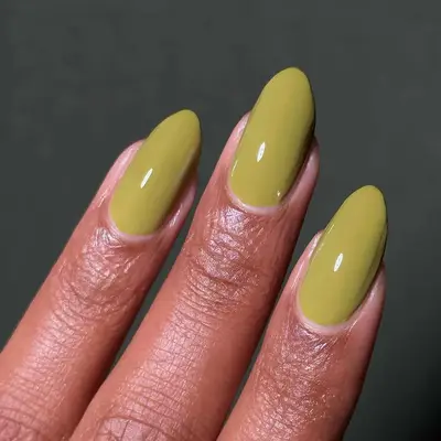 close up of an olive green manicure