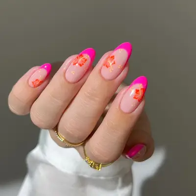 Manicure with orange and red hibiscus design and hot pink French tips