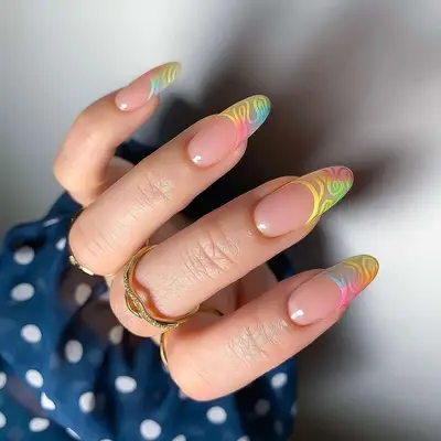 Manicure with ombre rainbow swirl design on French tips