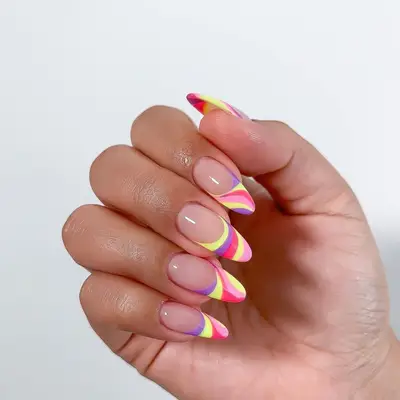 Manicure with pink, purple, and yellow pastel swirl French tips