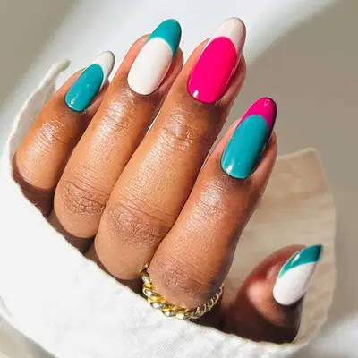Magenta, teal, and white color blocked manicure with French tips