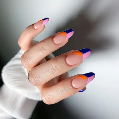 Manicure with navy, pink, and orange color-blocked French tips