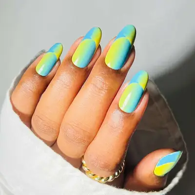 French manicure with blue and green ombre design and reversed tips