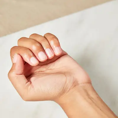 Woman with bare fingernails