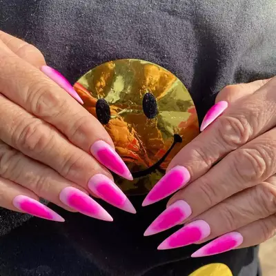 Long stiletto nails with bubblegum pink aura nail design 