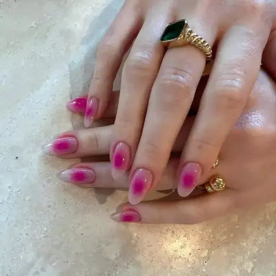 Coffin nails with a hot pink aura design and metal accents