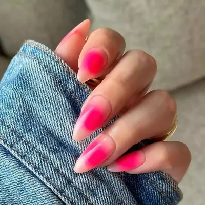 Long almond nails with bold pink colors and aura nail design